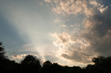 rays of sunlight through clouds outdoor. cloudy sky in summer
