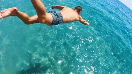 Athletic Young Man Jumping in the adriatic sea