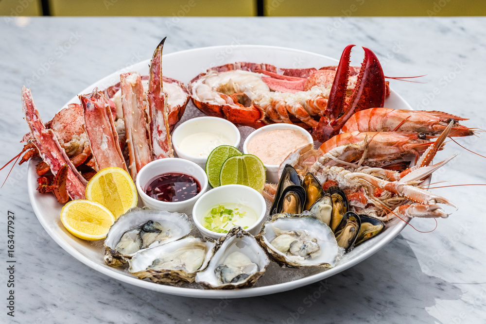 Wall mural fresh seafood platter with lobster, mussels and oysters