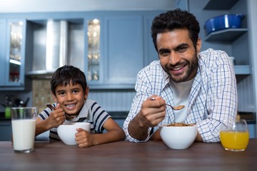 Fototapeta na wymiar Portrait of father and son having breakfast