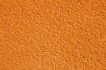 Orange plaster wall background texture pattern.