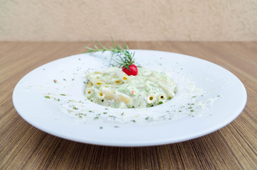 Italian penne with basil and chicken meat