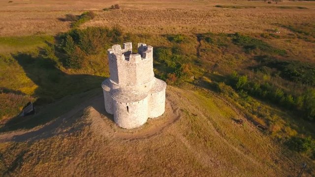 Aerial jaw shot of medieval church at sunset 4K