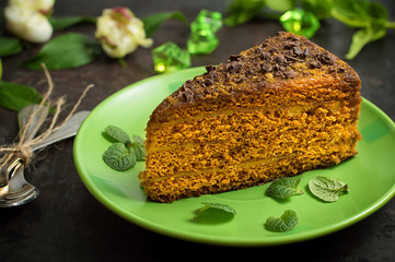 Cake with chocolate, honey and mint. Black background. Top view. Close-up