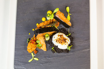 Confiture of salmon with cuttlefish ink with tomato sponge and egg suv