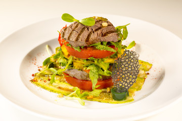 Grilled meat with vegetables served as a sandwich.