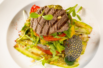 Grilled meat with vegetables served as a sandwich.