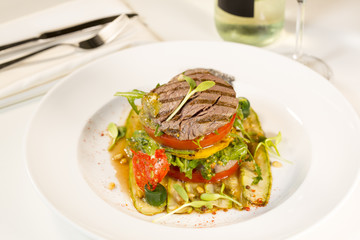 Grilled meat with vegetables served as a sandwich.