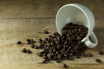 Coffee cup and coffee beans on table