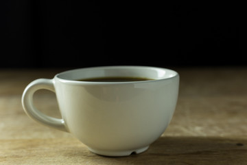 Cup of coffee on wood