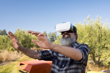 Happy man using virtual reality headset in tractor