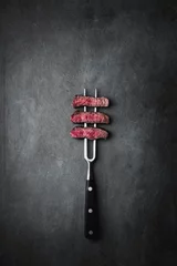 Fotobehang Steakhouse Beef on a meat fork on a background