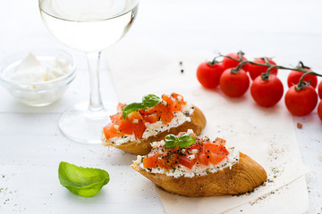 Bruschetta with cream cheese, tomatoes and basil