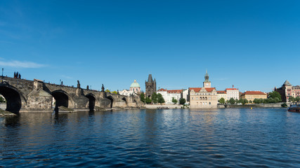 Charles Bridge, tower, and Vltava embankment viewed from the river, Prague