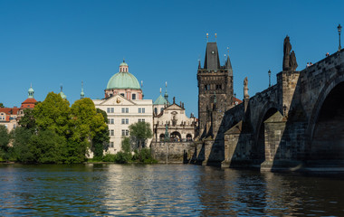 Charles Bridge, tower, and Vltava embankment viewed from the river, Prague