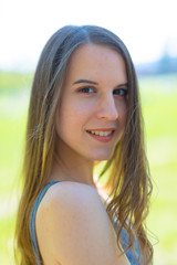 Head Outdoor Portrait of a slim girl with long hair in the nature