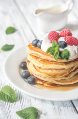 Pancakes with whipped cream and fresh berries