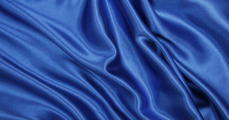 Smooth elegant blue silk or satin luxury cloth texture as abstract background. Luxurious background design