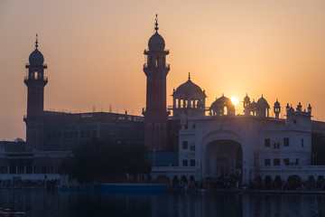 Fototapeta na wymiar The Golden Temple at Amritsar, Punjab, India, the most sacred icon and worship place of Sikh religion. Sunset light.