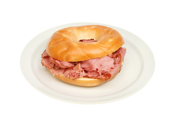 Pastrami in a bagel on a plate