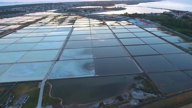 Aerial of seasalt squares with reflection of blue sky 4K