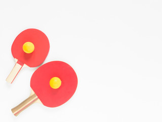 Sport background. Red ping-pong rackets and balls. Flat lay, top view.