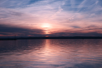 Sunset over the balaton lake. It is one of the largest lakes in Hungary - a common summer point of the spill. A place of life for many species of birds and fish.