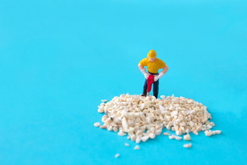 Obraz premium small figure of a man digging concrete street , Work in Progress concept