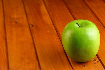 green apple on wood rustic table