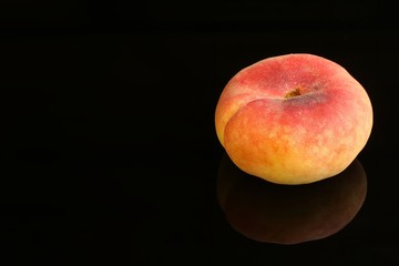 Close up shot of a fresh peach isolated on a black background
