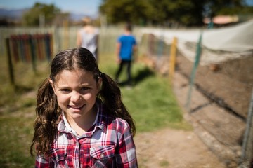 Smiling girl standing in the ranch