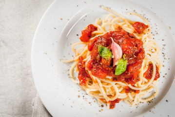 Italian cuisine. Lunch or dinner. A serving of spaghetti pasta with tomato marinara sauce and basil...