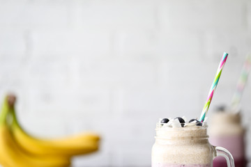 Copy Space Blueberry Coconut Layered Smoothie on the White Brick Background