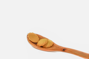 Cookies onto wooden spoon on white background