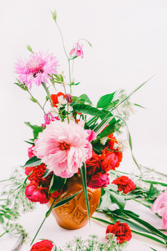 Floral design. A beautiful bouquet of pink peonies, cornflowers and red roses, toning photo