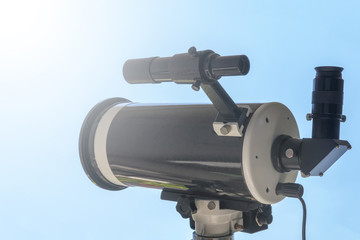 Solar eclipse observing with telescope. Telescope with solar filter.