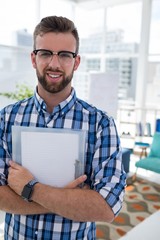 Male executive holding document in the office