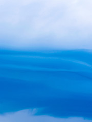 Unusual beautiful clouds with lines on a blue sky, float high above the ground