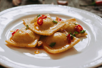 Itallian food. Home ravioli with prawns, garlic and chili pepper.