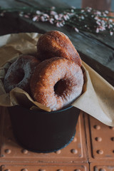 Donuts in a metal bucket. Sugar. Fast food.