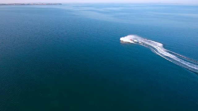 Scooter driving like crazy on sea aerial view 4K