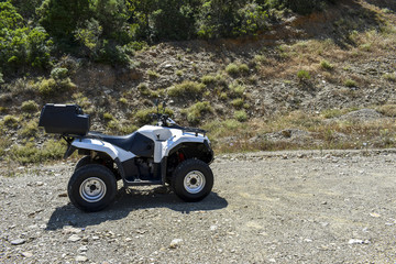 ATV offroad on mountain and sky background.