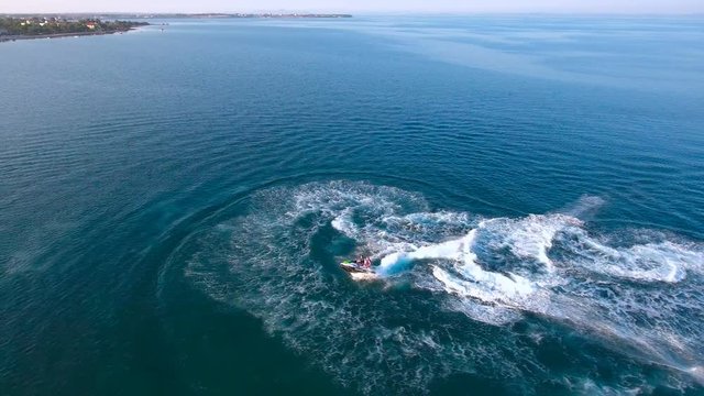 Scooter jumping on sea surface aerial view 4K