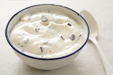 Stracciatella yogurt in small bowl with white spoon - 163498951