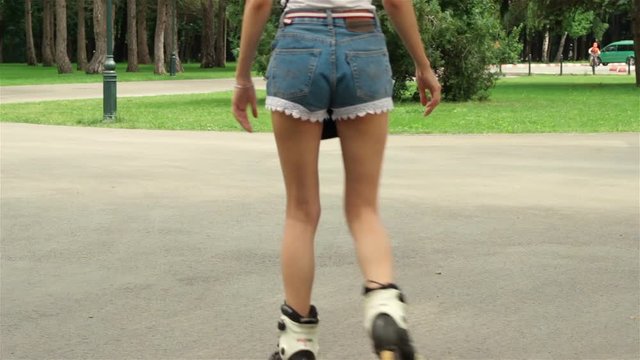 young girl in shorts rollerblading