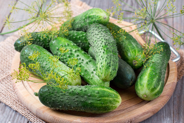 Fresh cucumbers on wooden background. Whole cucumbers