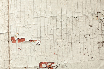 Cracked wall with old layers of paint in abandoned house