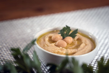 Hummus on a rustic wooden table