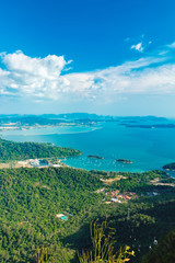 View of blue sky, sea and mountain seen from Cable Car viewpoint, Langkawi, Malaysia. Picturesque landscape with town among the tropical forest, beaches, small Islands in waters of Strait of Malacca