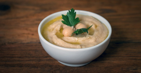 Hummus on a rustic wooden table